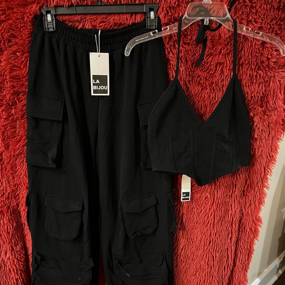 Super cute never worn with tags. Black cargo pants with halter top.
